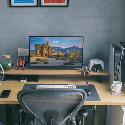 Person using computer with ergonomic workspace setup
